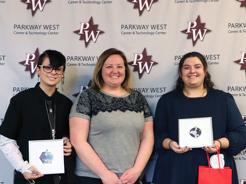 Local students Joey Clark and Angelina Kinest unveiled their winning space mission patch designs at a recent presentation hosted by Parkway West Career & Technology Center. Pictured left to right: Joey Clark, Parkway West CTC instructor Betsy Zelina and Angelina Kinest.