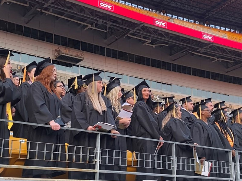 Students in graduation regalia lined the stands at Acrisure Stadium on Thursday evening.