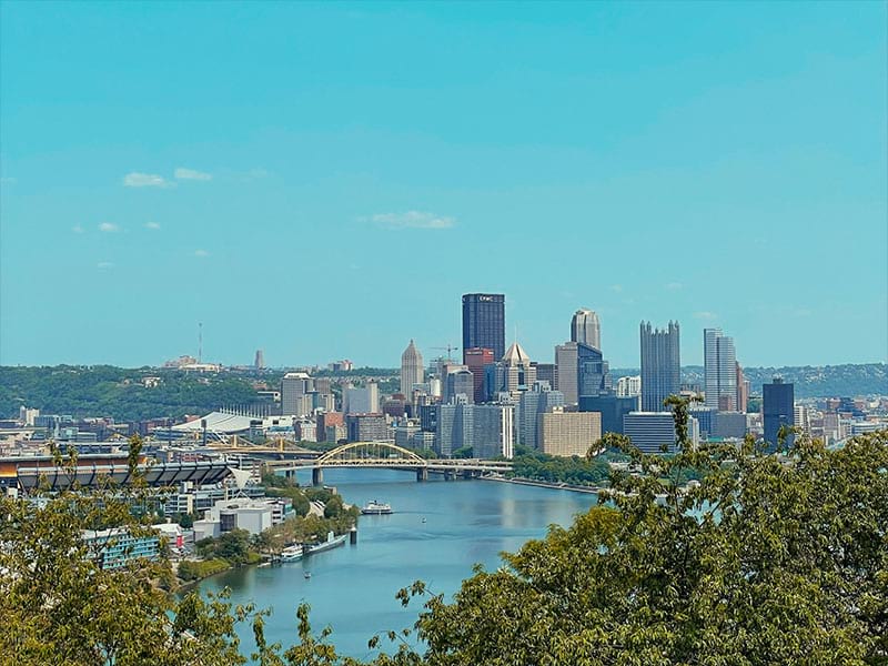 Aerial view of Pittsburgh featuring the North Shore and Acrisure Stadium, the Allegheny and Ohio rivers, and the Golden Triangle.