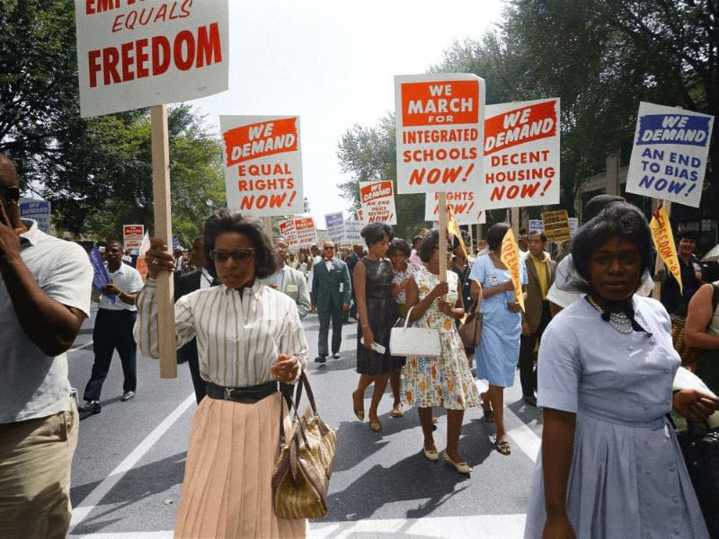 Protesters march in a historic photograph from the Civil Rights Movement.