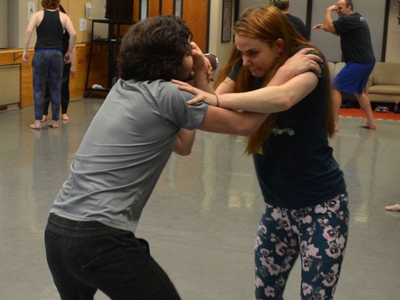 Pairs of students practicing unarmed techniques in a Stage Combat class at South Campus.