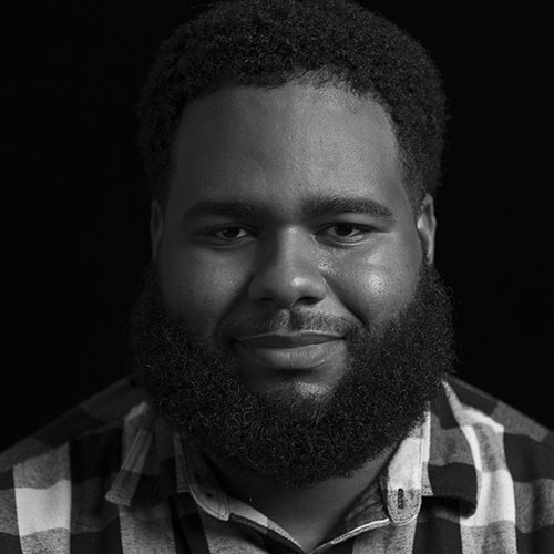 A black and white headshot of Jaquan Brookman